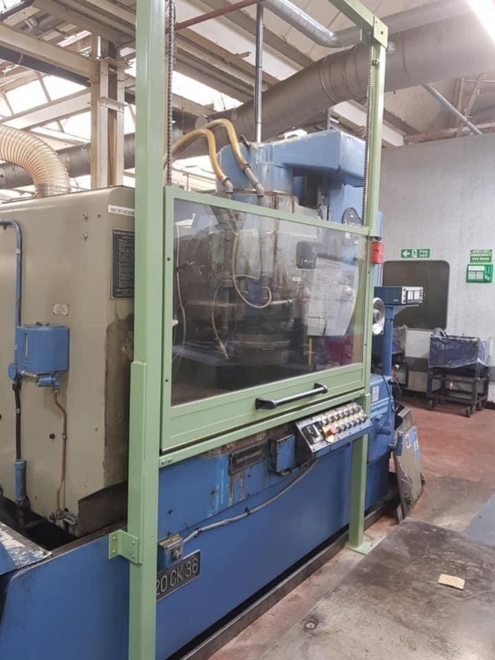 Rise and fall door on blanchard grinder 